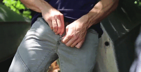 Pulling bulging cock from jeans stroking